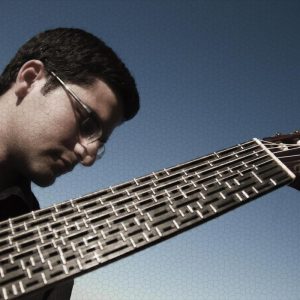 Tolgahan Çoğulu with one of his microtonal nylon string acoustic guitars